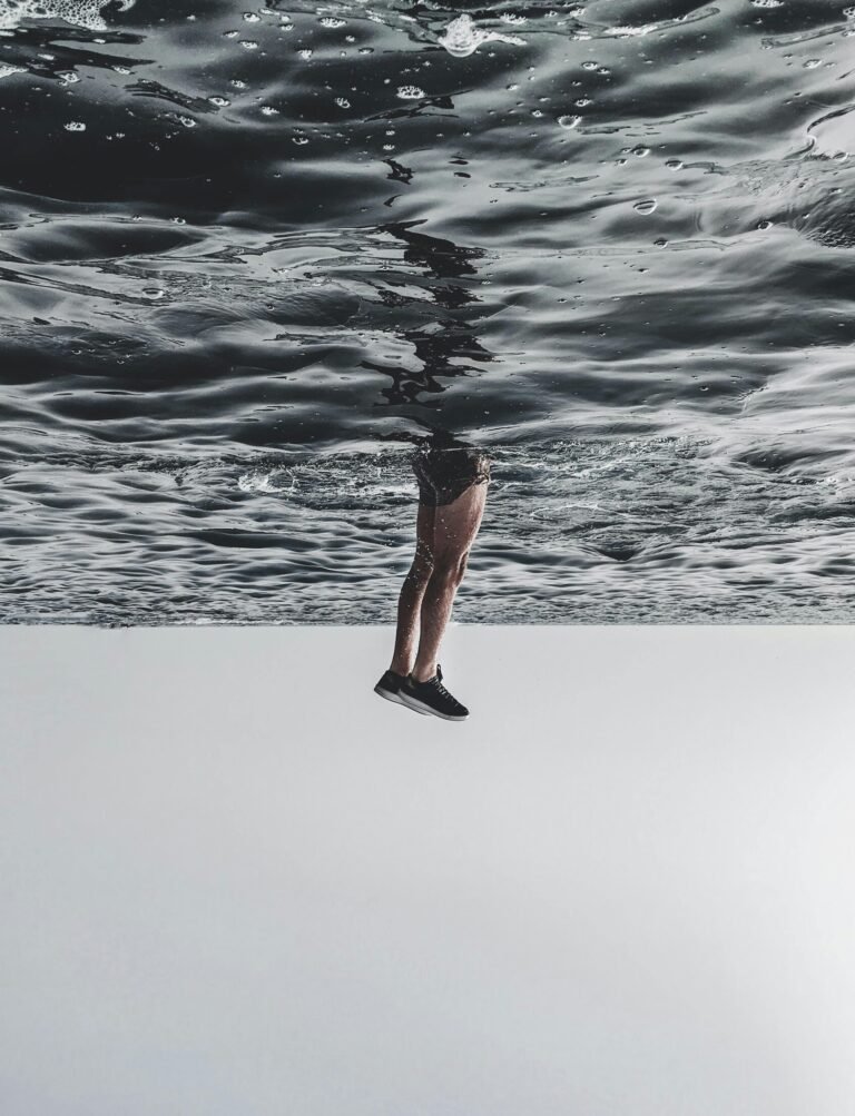 A surreal image of legs appearing to walk on the ocean surface, creating a dreamlike effect.